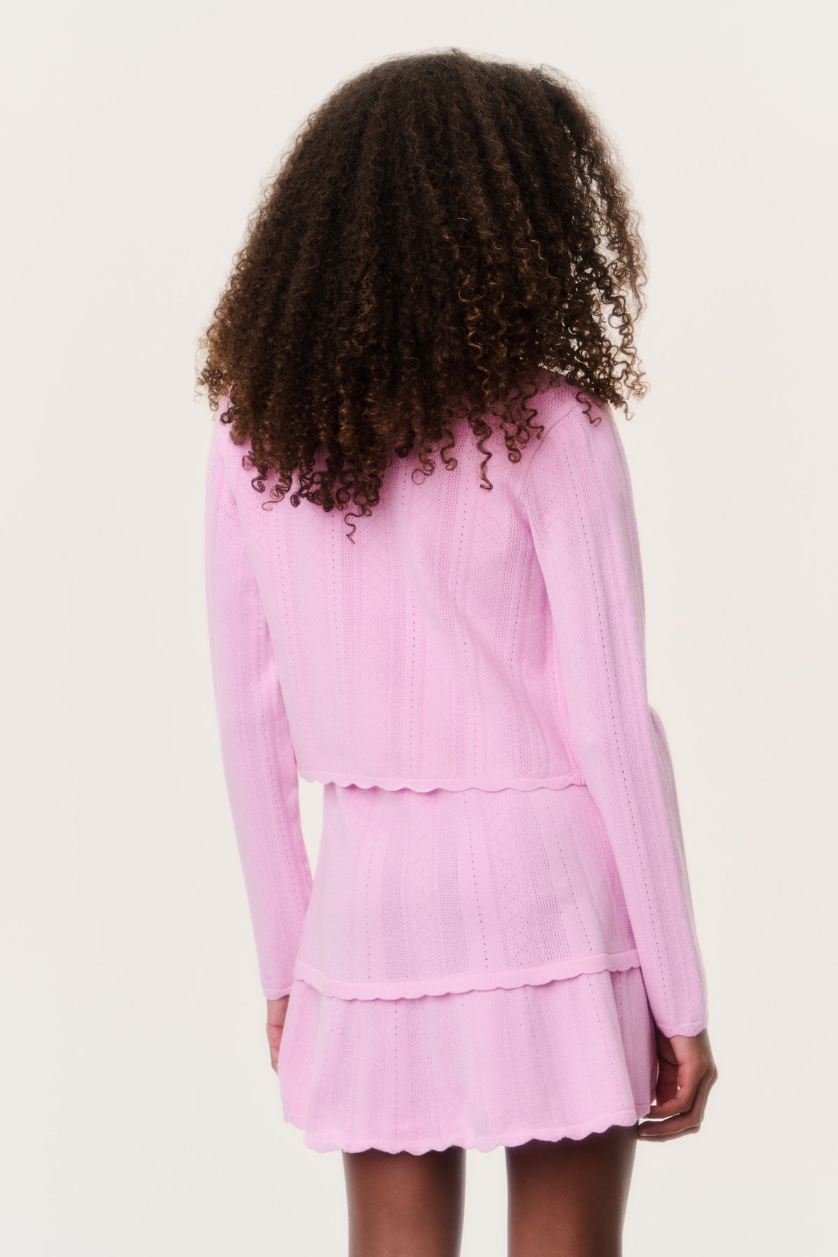 Tween pointelle cardigan, light pink button-front with tiered ruffle hem (back)