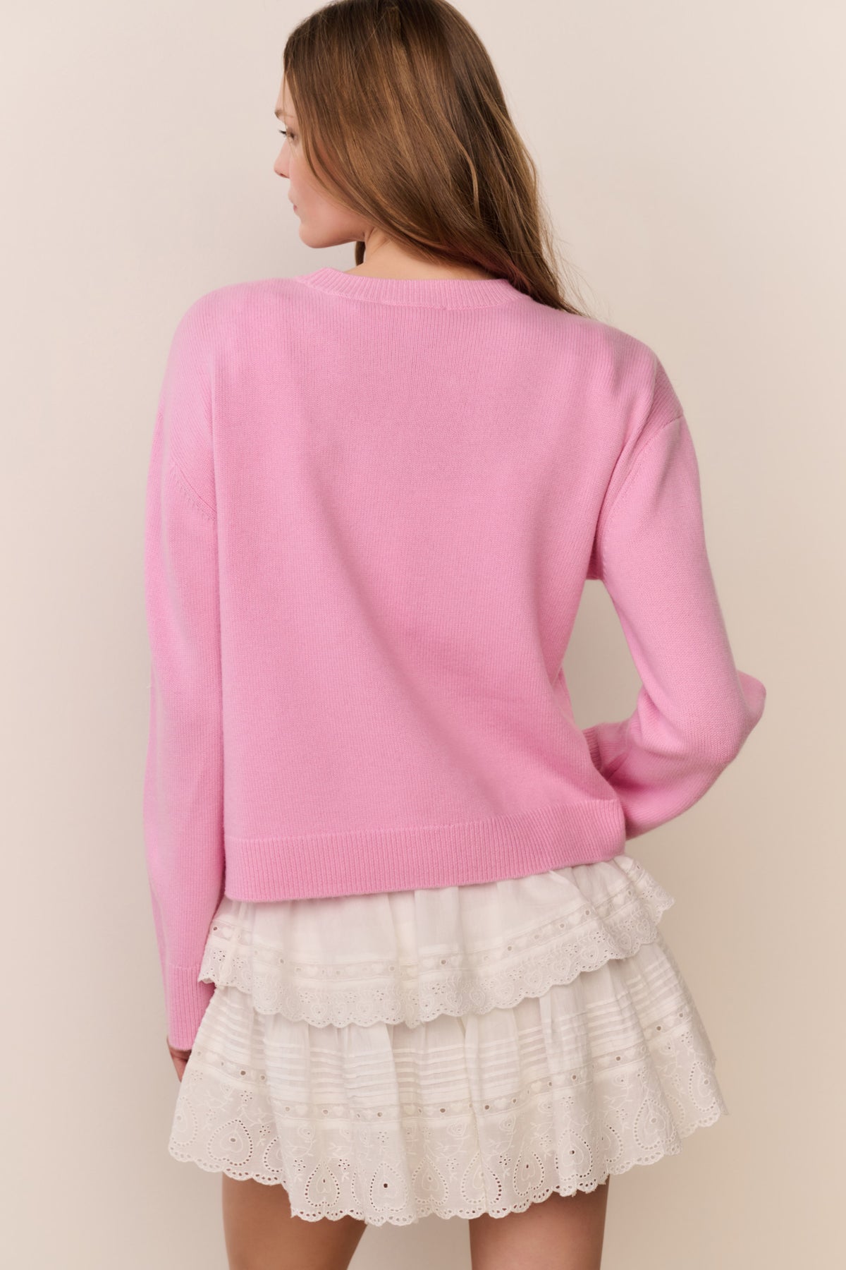 Pink pullover back view with ribbed hem and long sleeves