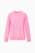 Pink wool-cashmere heart pullover with crew neck, long sleeves, and ribbon bow detail