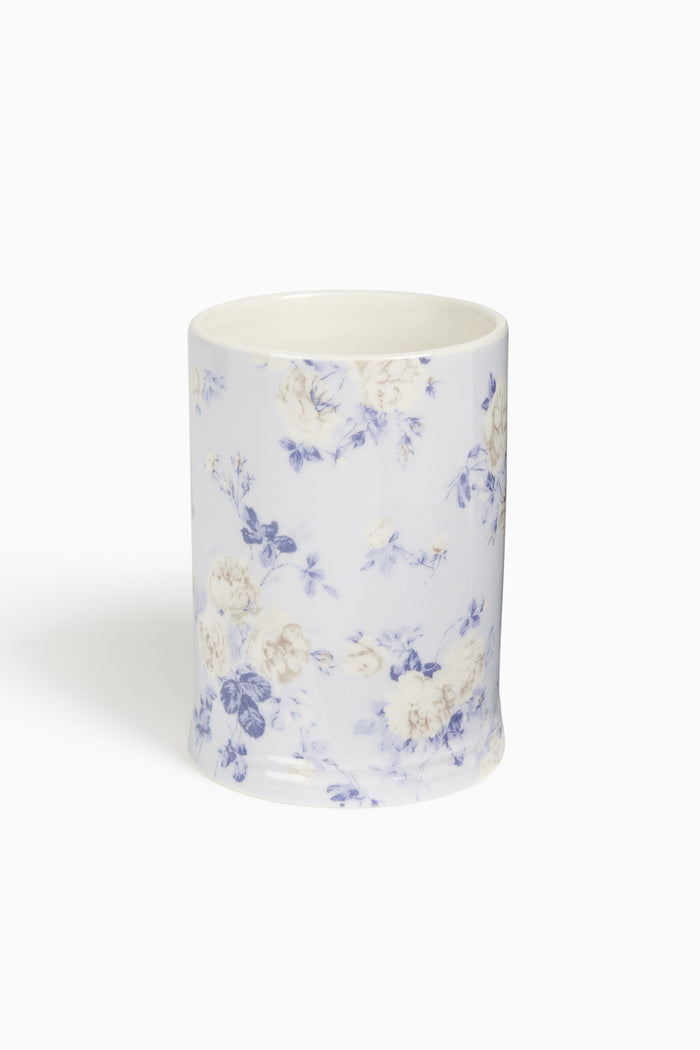 Porcelain tumbler with blue floral pattern on white