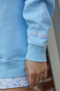 Lavender pullover sweatshirt with ribbed cuffs and small chest logo graphic