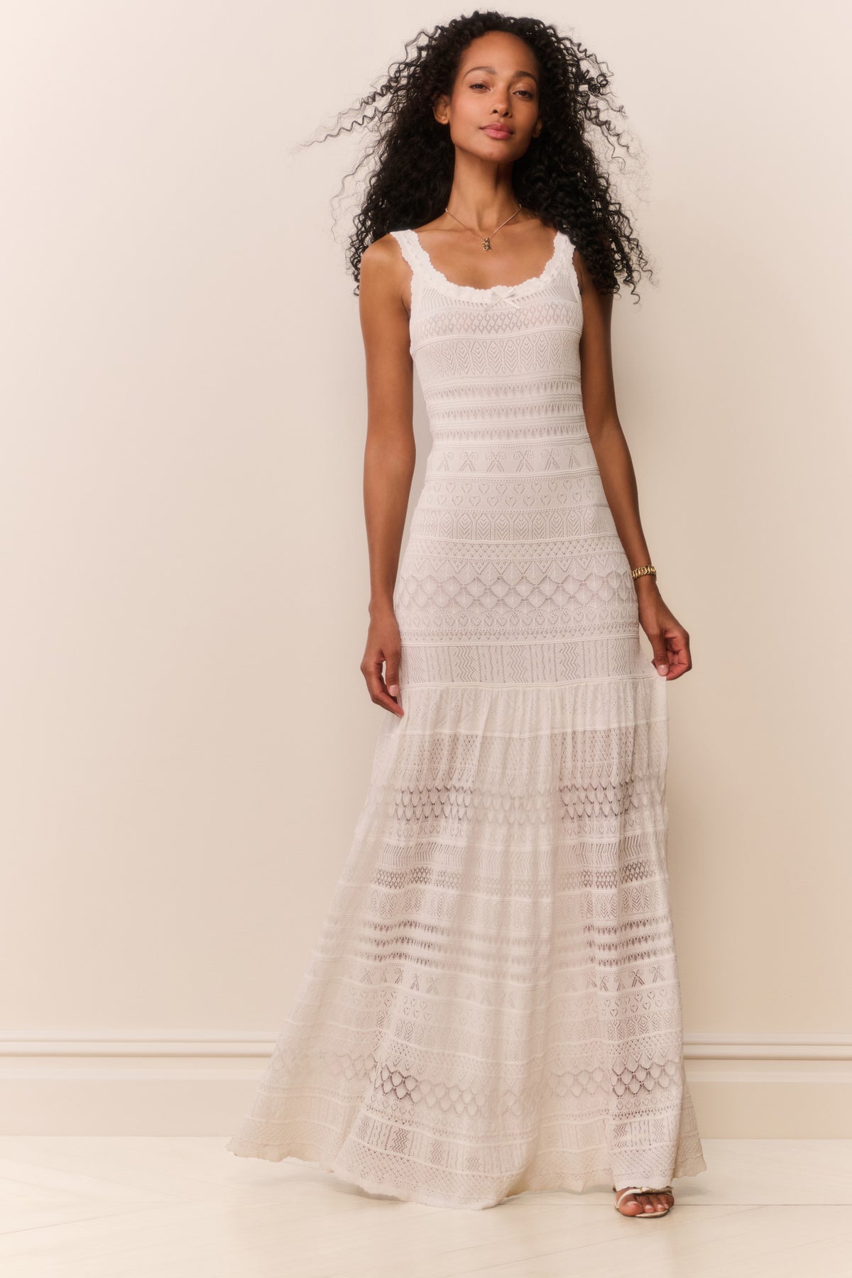 White sleeveless pointelle maxi dress with spaghetti straps and tiered textured skirt