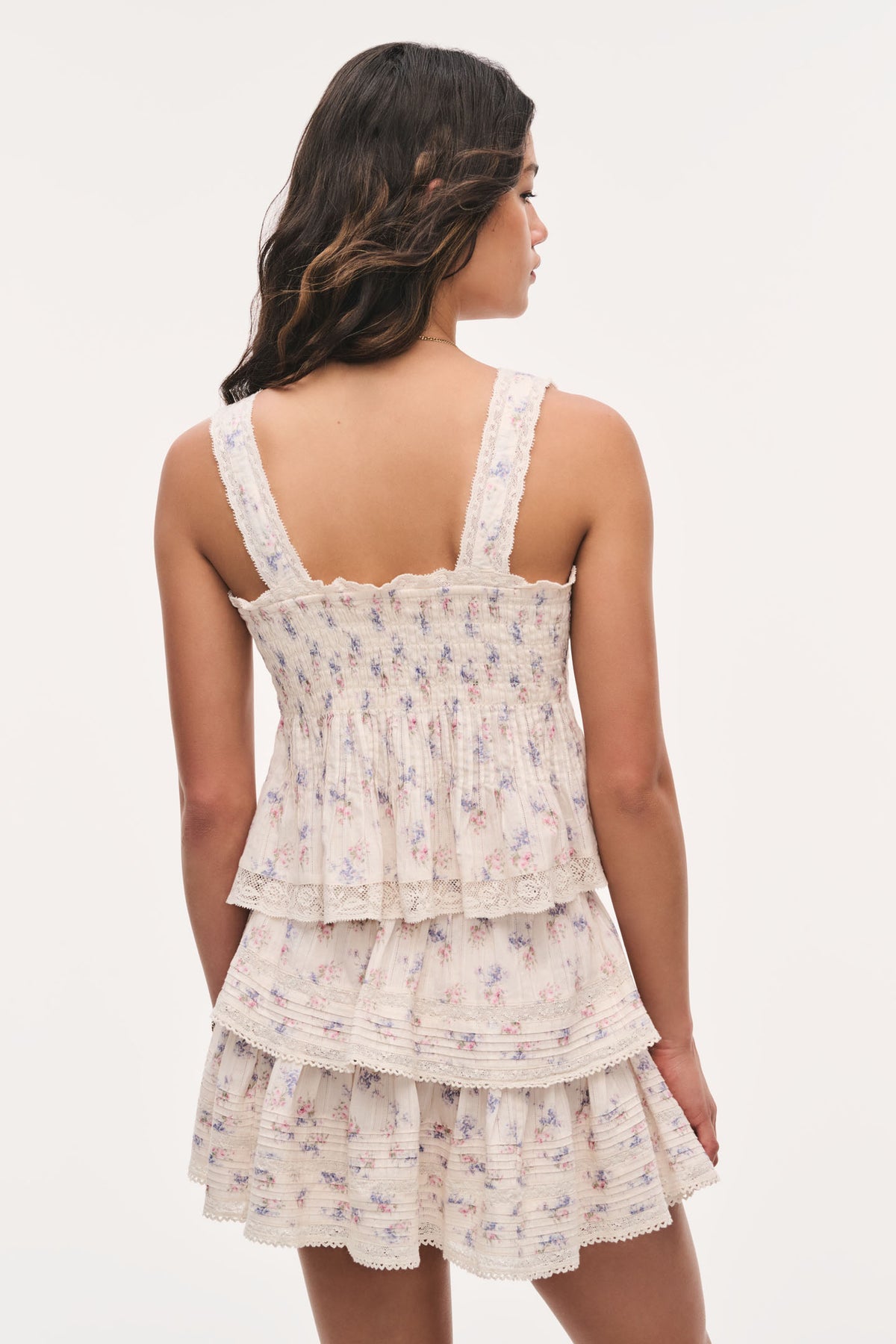 Back view: antique vanilla floral cotton top with lace-trim straps and tiered hem