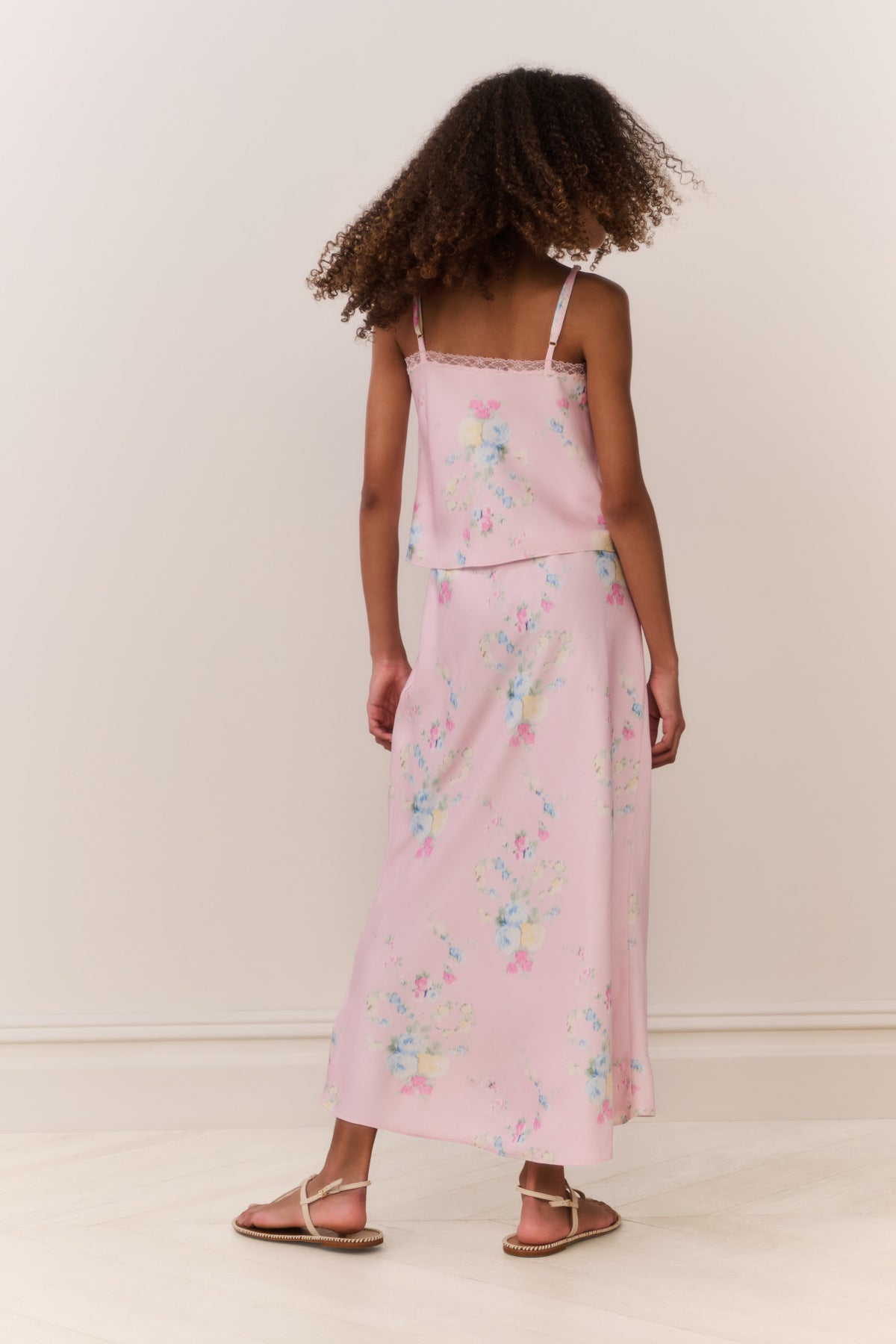 Back view of light pink floral maxi skirt with scattered pastel flowers