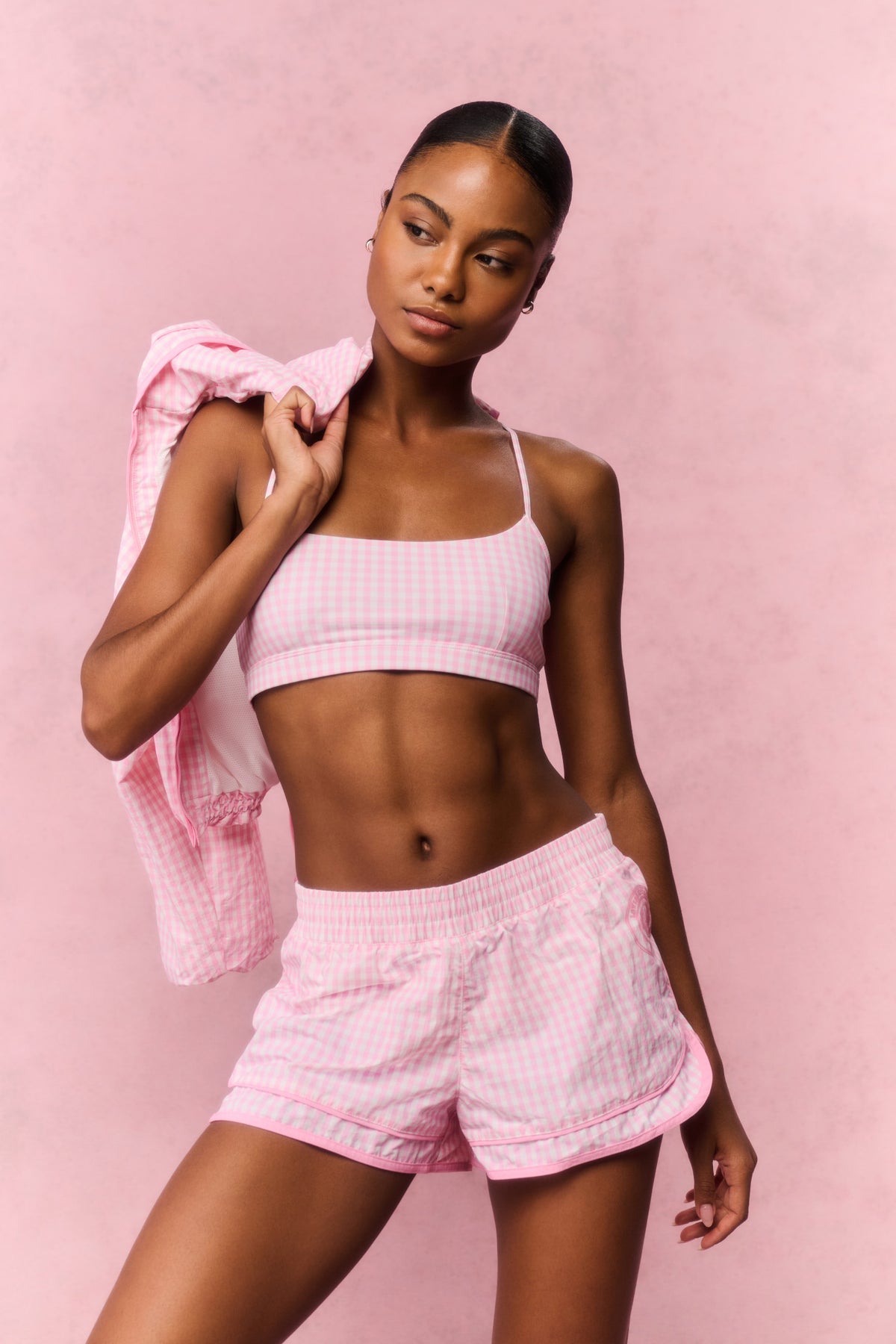 Pink sports bra with thin straps and geometric lattice pattern, front view
