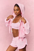 Pink gingham windbreaker with hood up and full zip front, cropped and gathered hem.