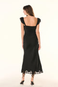 Black lace ruffled-sleeve slip dress, open back, scalloped lace hem.