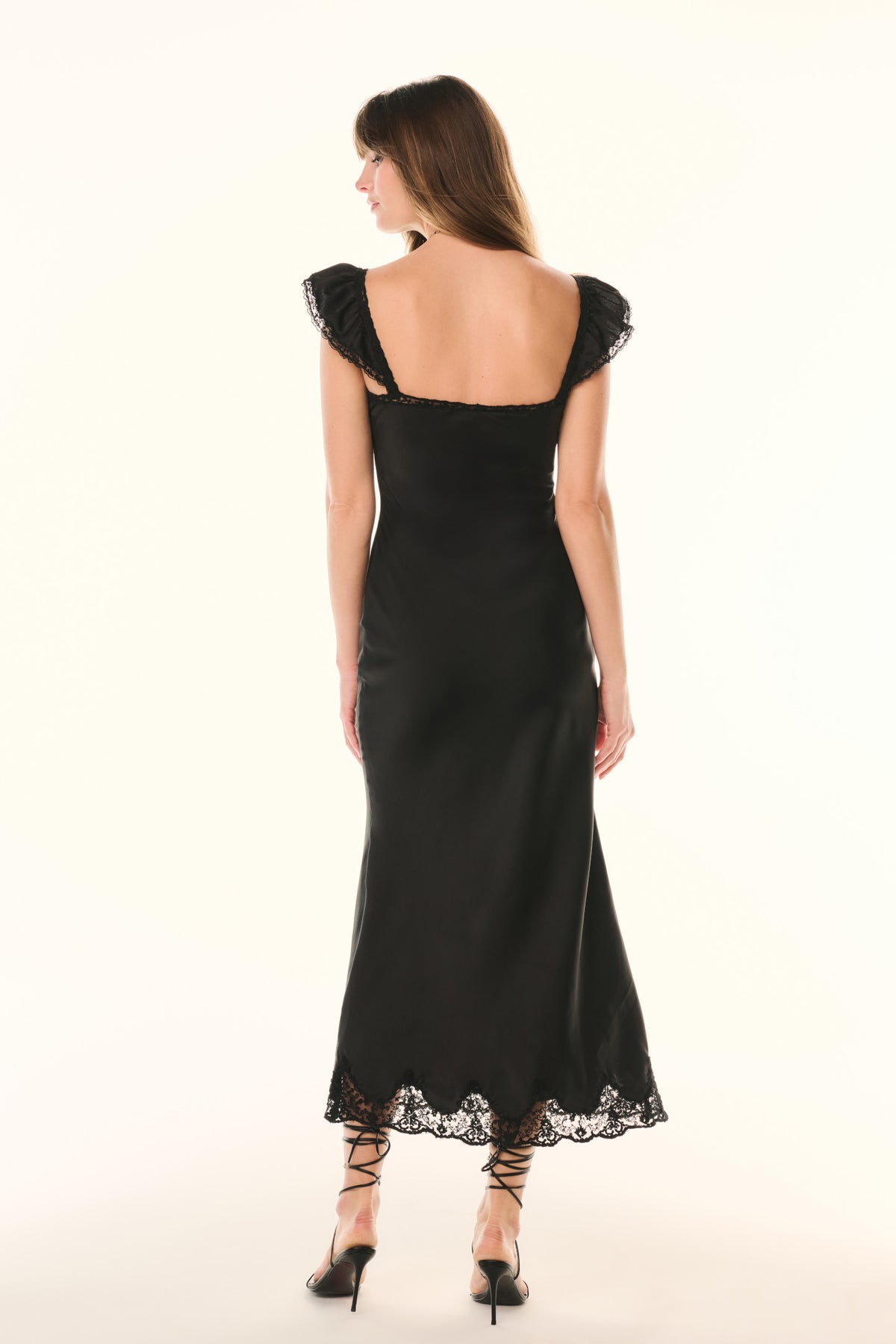 Black lace ruffled-sleeve slip dress, open back, scalloped lace hem.