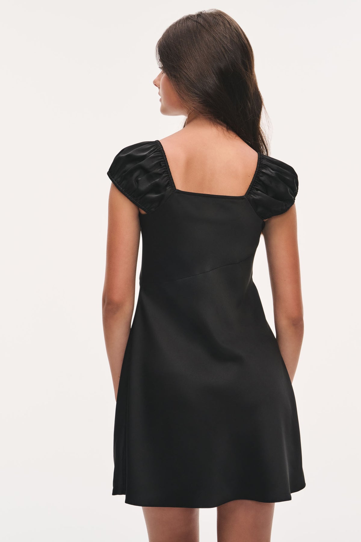 Black mini dress with short puff sleeves and open square back