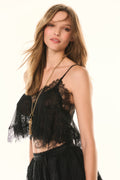 Black lace crop top with spaghetti straps and sheer floral lace overlay