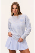Light blue tennis print pullover with crew neck, long sleeves, flared hem