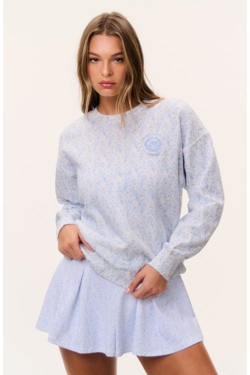 Light blue tennis print pullover with crew neck, long sleeves, flared hem