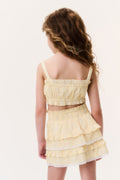 Girls pale yellow tiered ruffle mini skirt, back view