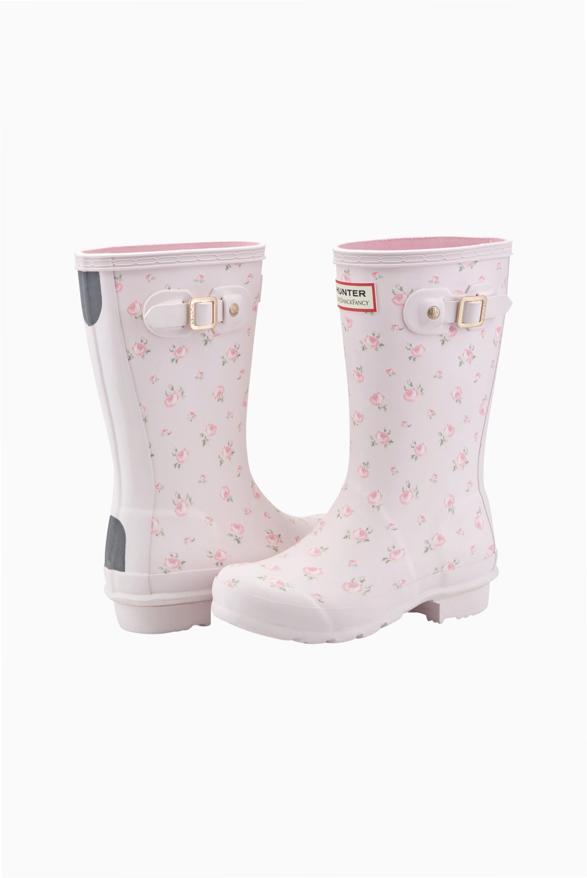 Pair of kids short rain boots in white with pink floral print and side buckles