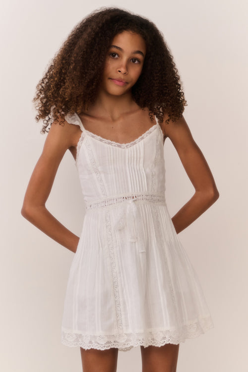 White cotton mini dress with thin straps, gathered skirt, scalloped lace trim