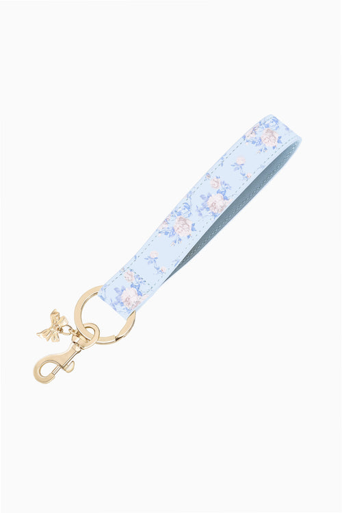 Keychain charm strap with light-blue floral rosette print and gold clasp rings
