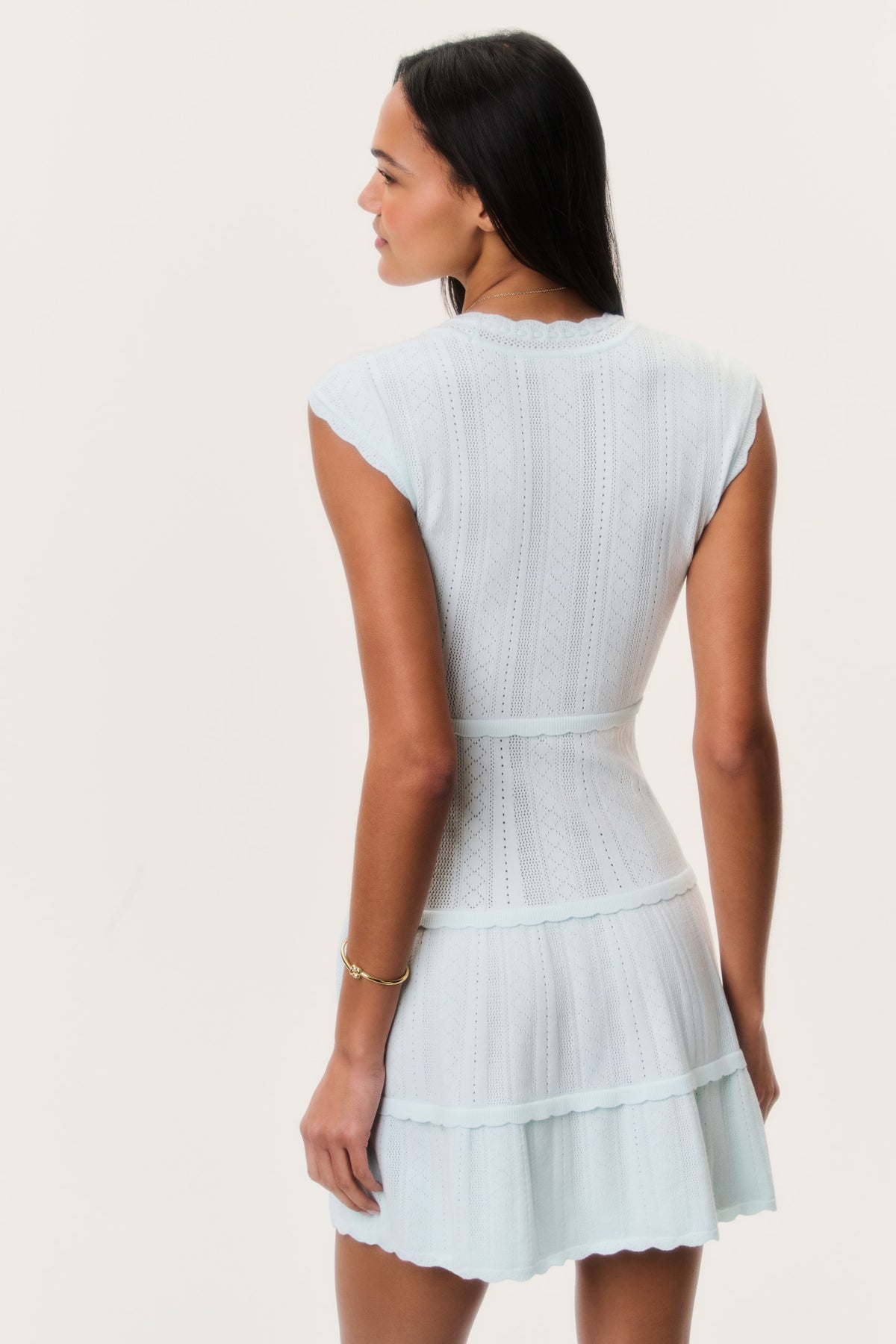 Back view of dusty lagoon blue stretch pointelle mini dress with tiered ruffle skirt