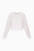 True white fleece pullover with eyelet-style floral cutout sleeves