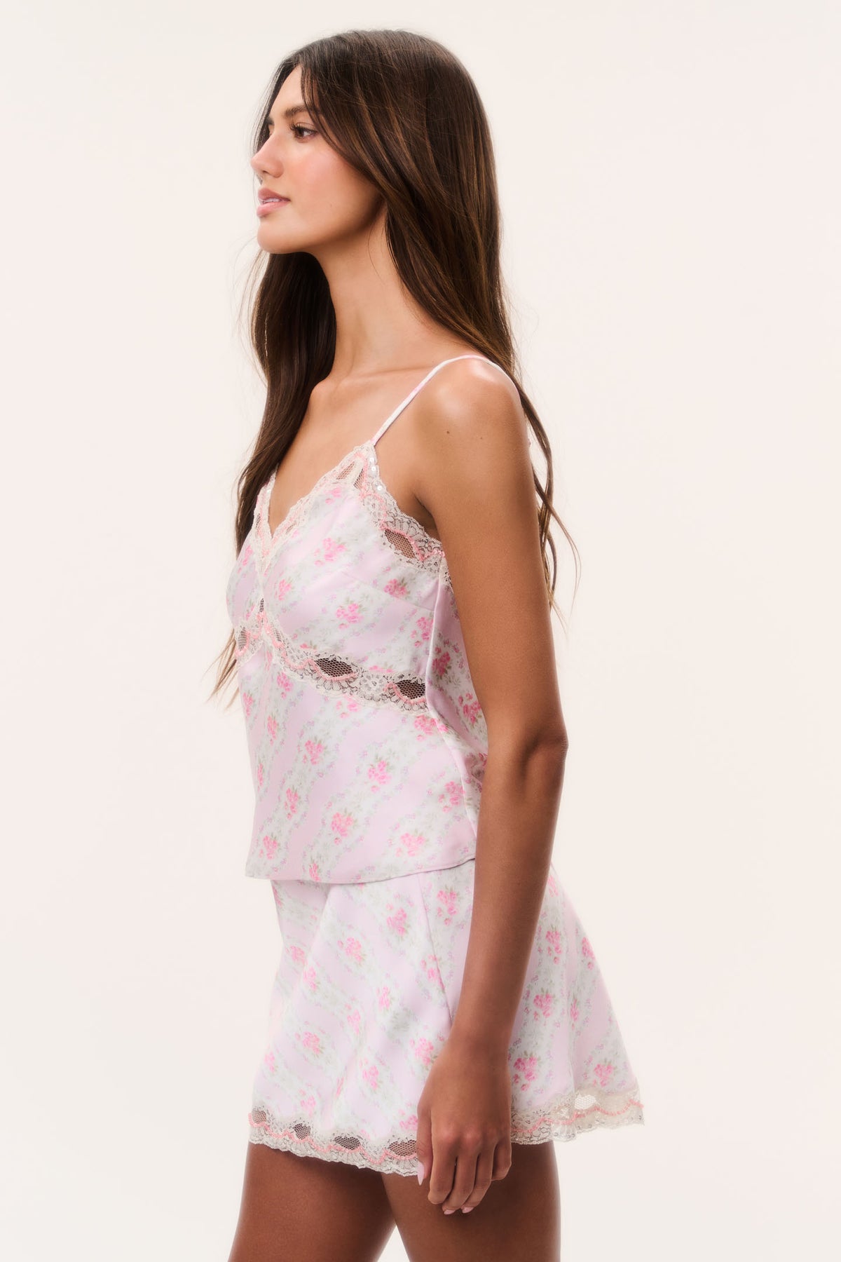 Floral satin camisole top side view, spaghetti straps and lace trim on light blue