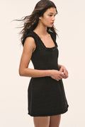 Black tweed mini dress with sleeveless square neck and embellished trim, side view