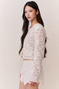 Ivory lace mini shorts with scalloped edges, worn side view