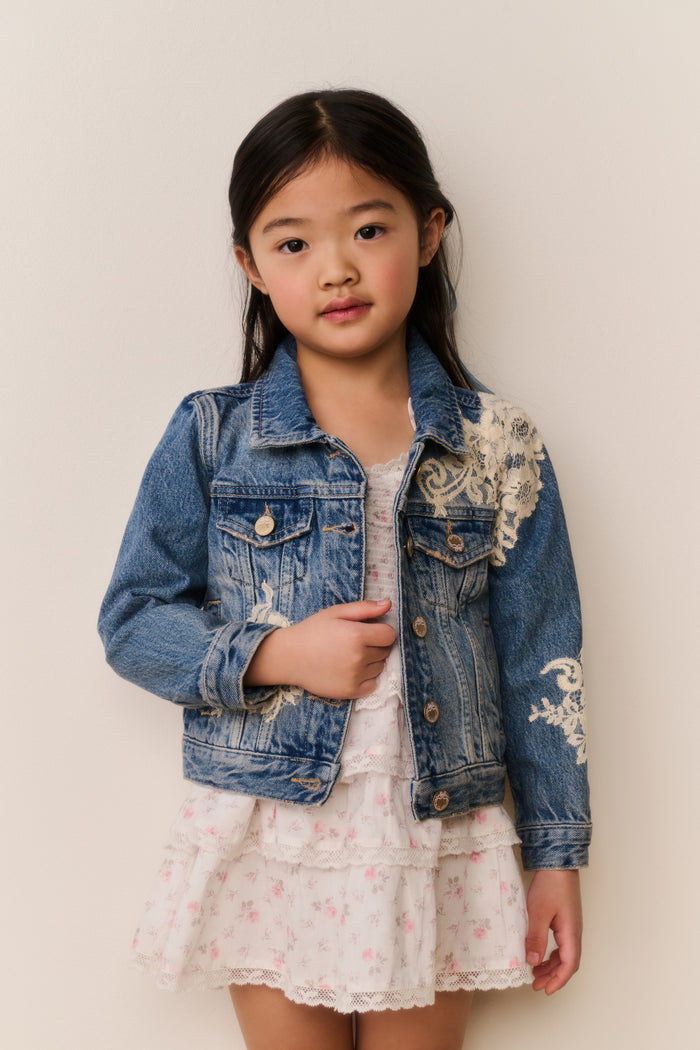 Girls' faded blue denim jacket with front pockets, embroidered panels, button closure