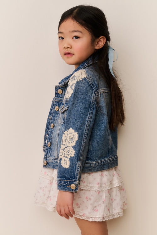 Girls' faded blue denim jacket with embroidered floral patches and button cuffs
