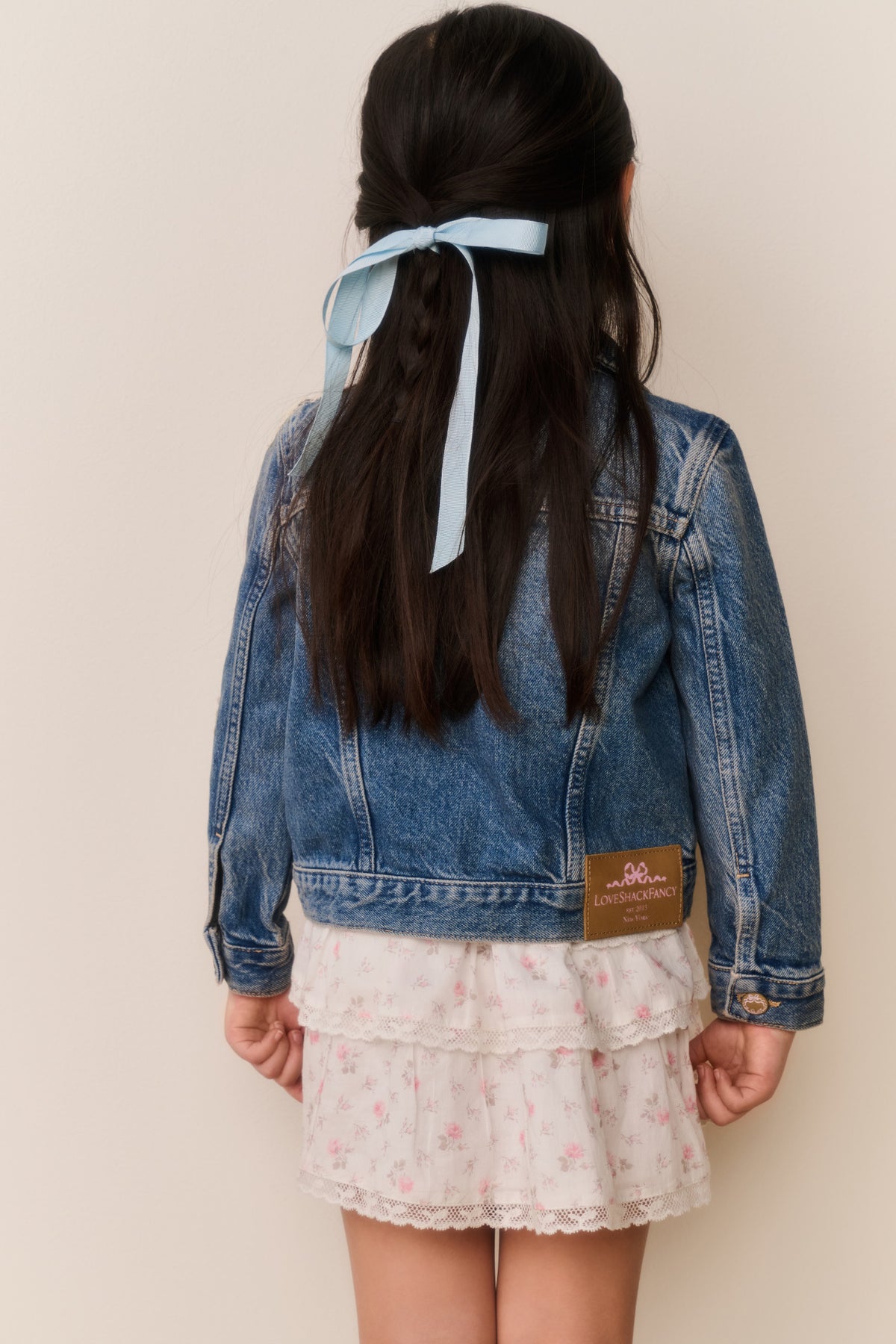 Girls' faded blue denim jacket with button back and embroidered patch details