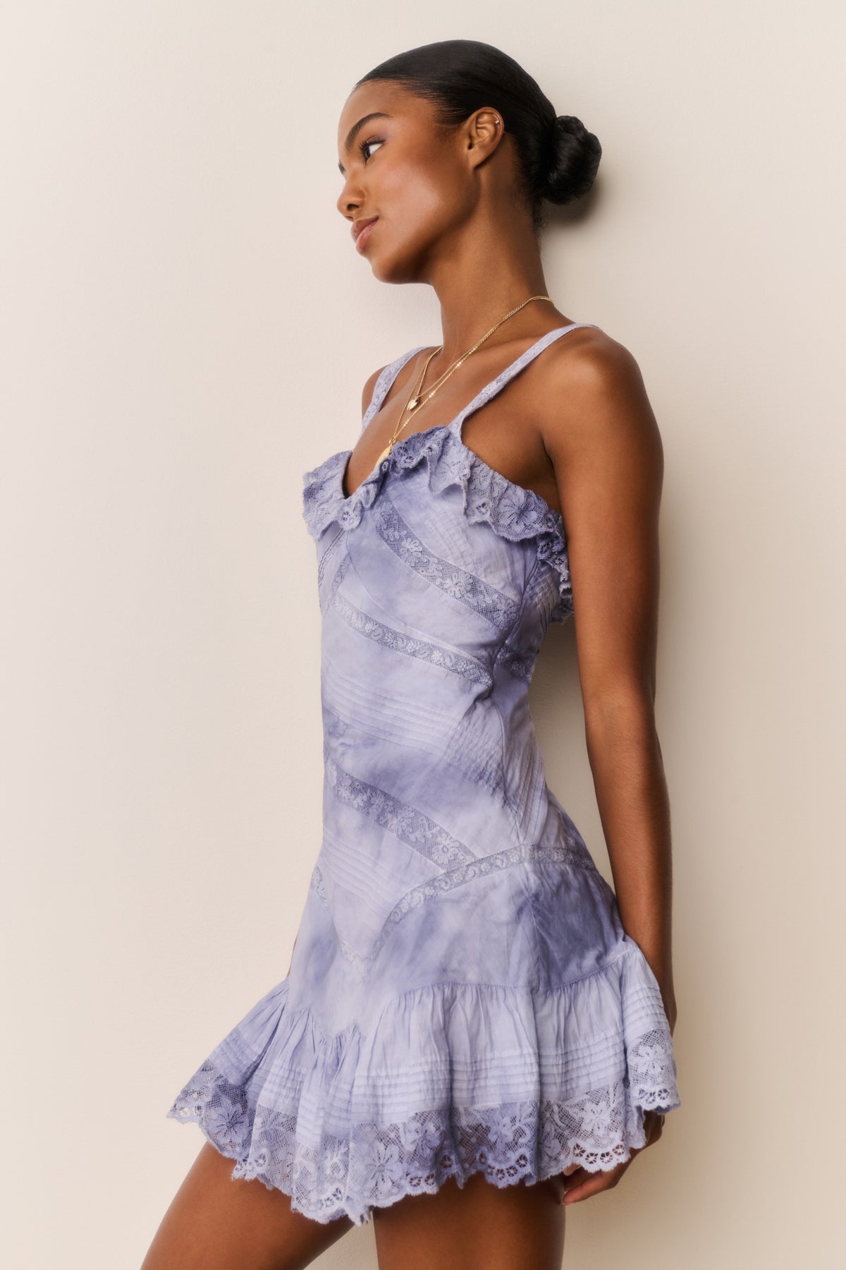 Indigo hand-dyed cotton mini dress, side view, spaghetti straps and tiered ruffled skirt