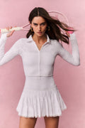 White eyelet active jacket with zip front and ruffled peplum hem, long sleeves