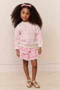 Girls pink heart-print pullover, crew neck, long sleeves; model standing