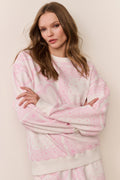 Pink heart-print fleece pullover close-up, long sleeves, crew neck