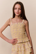 Tween floral top with smocked bodice, bow tie straps, and tiered ruffle hem