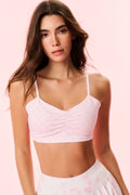 Pink patterned sports bra with thin spaghetti straps and gathered front