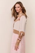 Wool-blend cardigan with long sleeves and allover novelty knit motifs over a pink dress