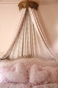 Heart-shaped ruffle pillow with pale pink floral print and gathered ruffle edges