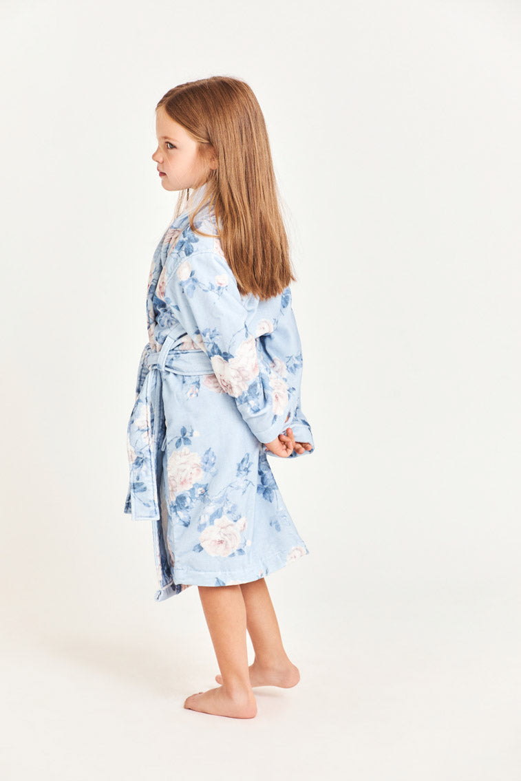 Kids cotton bath robe, light blue floral print, side view with tie belt.