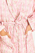 Pink cotton bath robe with bow belt tie and repeating floral pattern