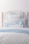 Blue floral ruffle bolster pillow with gathered frill ends