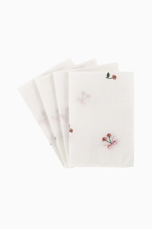 Stack of white embroidered napkins with small red and green motifs