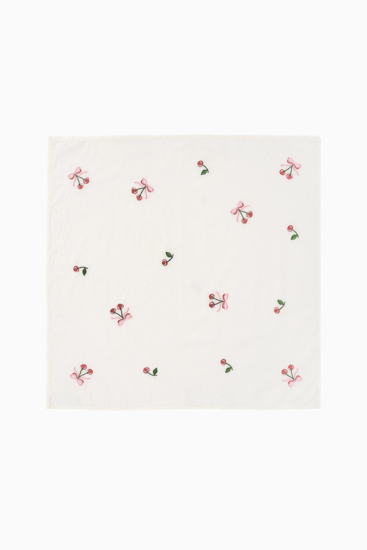 White embroidered napkin with scattered pink and red bow motifs