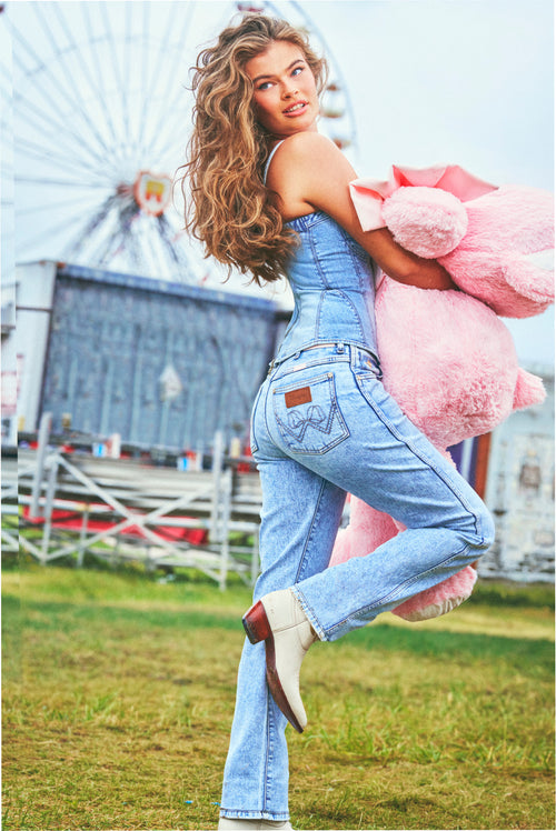 Light wash cowboy-cut denim jeans with button fly and stitched back pocket design
