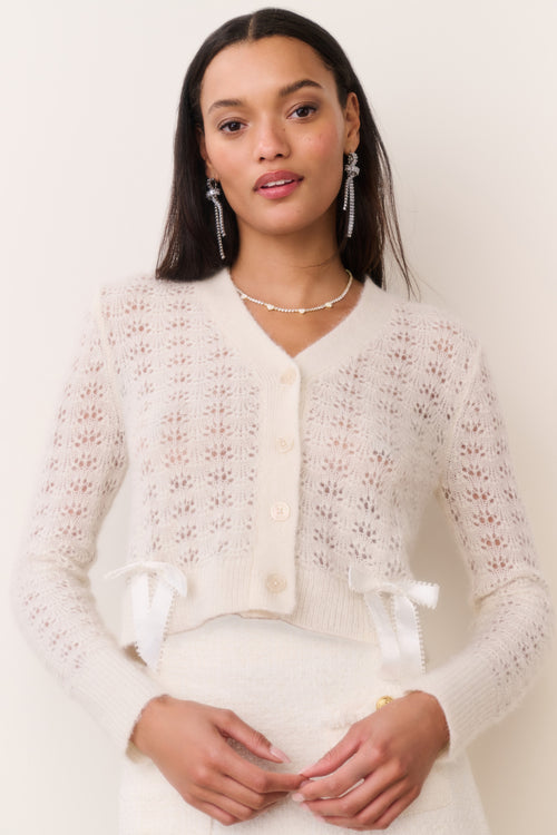Light cream knit bow cardigan, button-front V-neck with patterned texture and bow ties