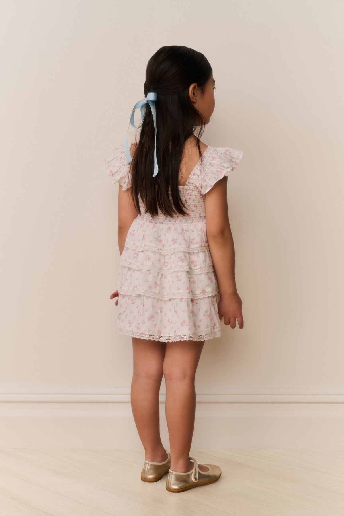 Girls' ivory floral cotton dress, tiered ruffles, cap sleeves; view from back