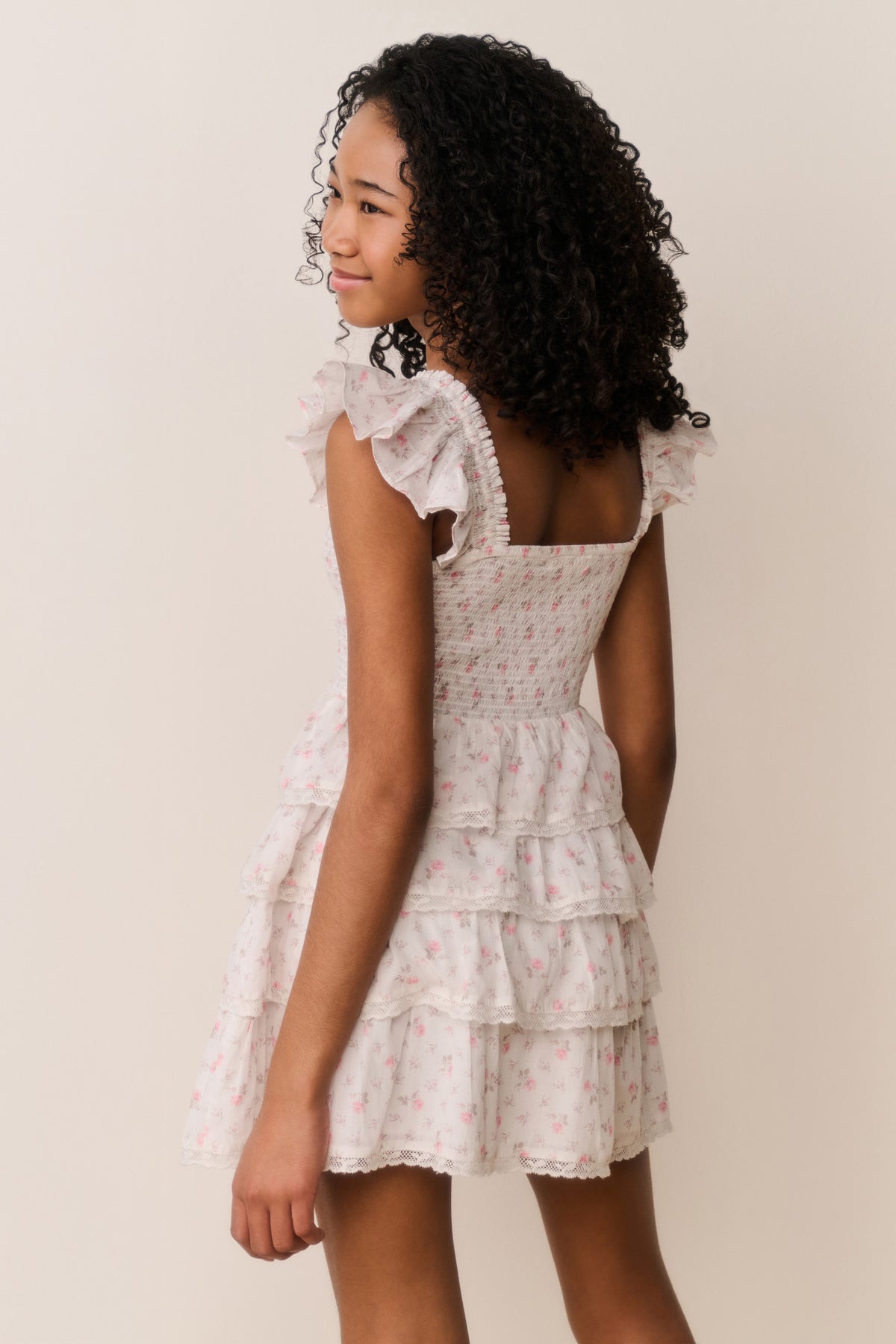 Ivory floral cotton dress with tiered ruffles and flutter cap sleeves, side view