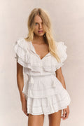 Antique white ruffled cotton mini dress with V-neck and tiered layers, short sleeves