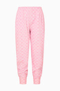 Pink printed cotton sweatpants with elastic cuffs and relaxed tapered legs