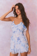 Silk mini dress with blue floral print, spaghetti straps, and ruffled tiered skirt.