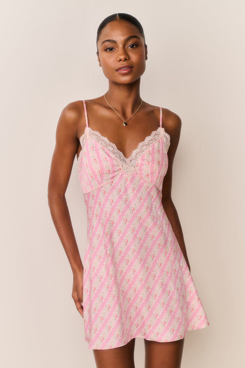 Pink floral print mini slip dress with lace-trim V neckline and scalloped lace bust