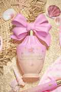 Pink Love on the Beach eau de parfum bottle with large bow on straw and seashells
